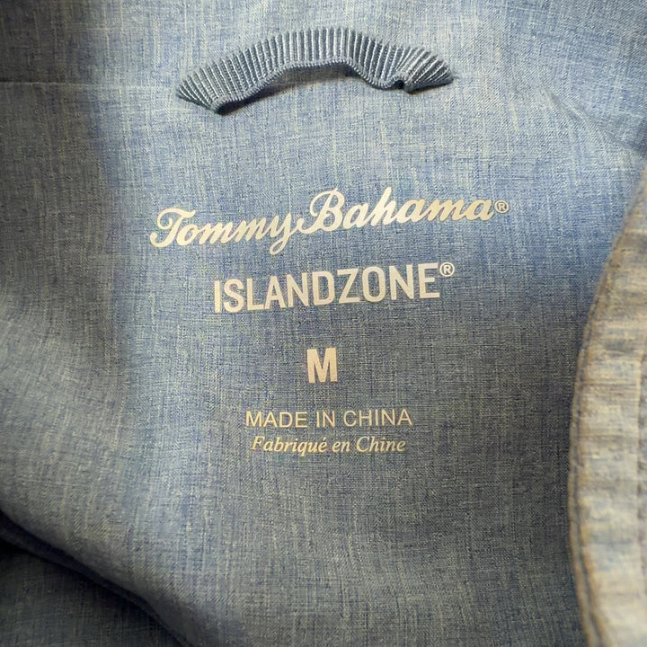 Tag view of light blue denim windbreaker jacket showing drawstring hem details