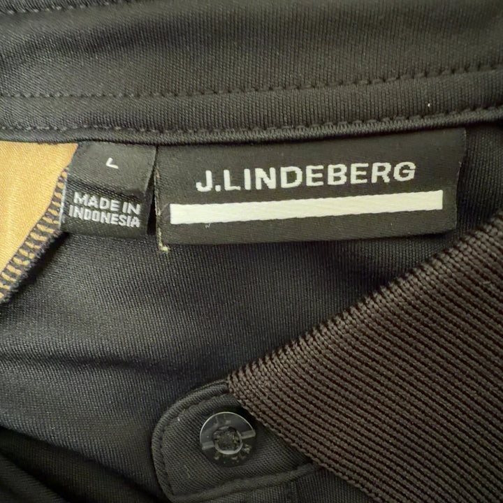 J. Lindeberg black and gold colorblock polo shirt back view, showing raglan sleeve design and tailored fit