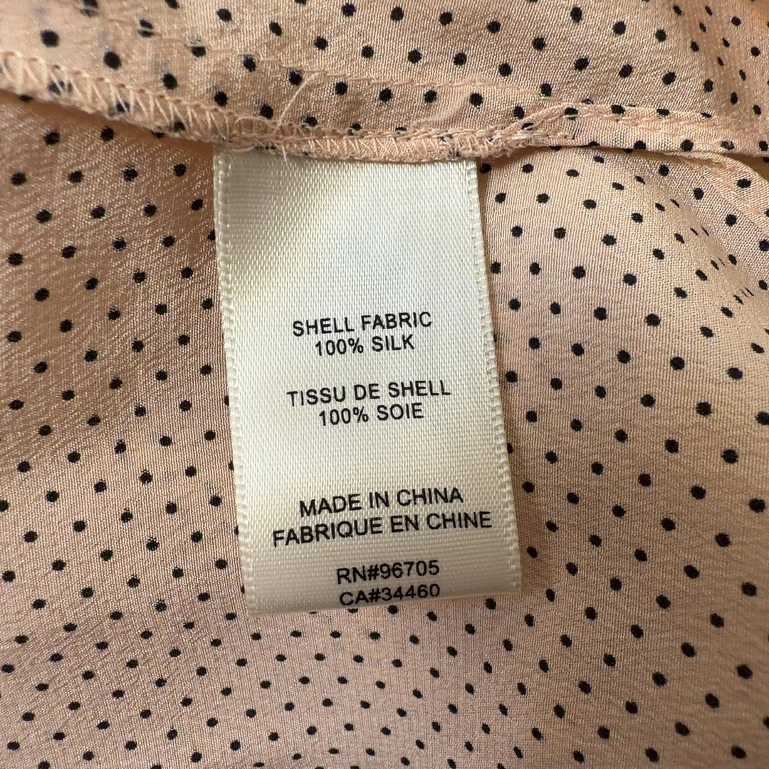 Tag view of cream silk pleated blouse showing relaxed fit and long sleeves
