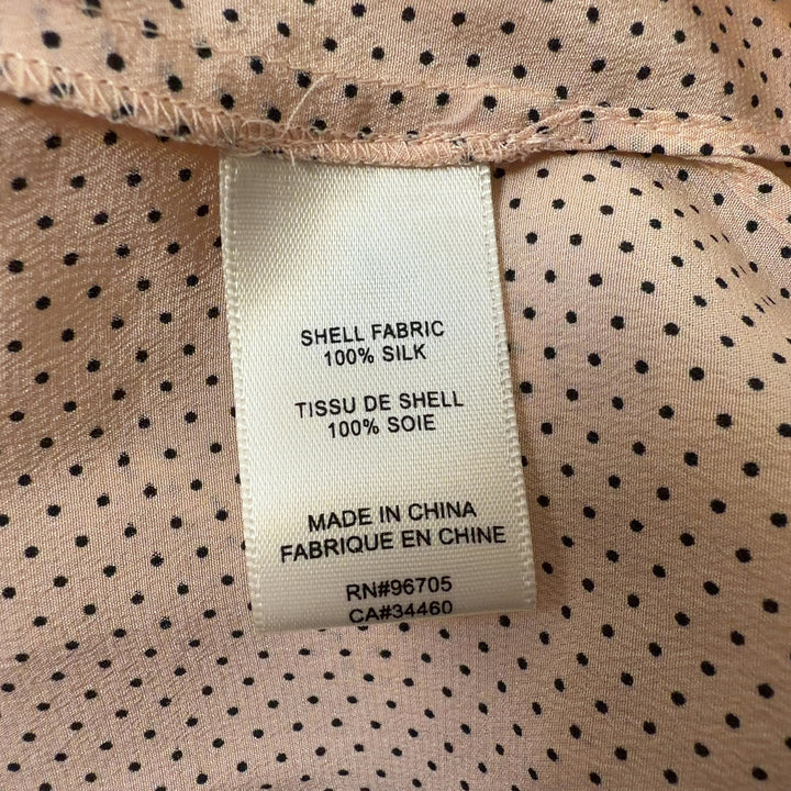Tag view of cream silk pleated blouse showing relaxed fit and long sleeves