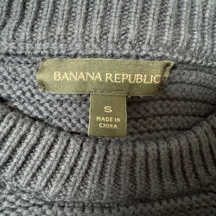 Navy ruffle shoulder knit sweater back view on model, showing textured knit and ruffle details