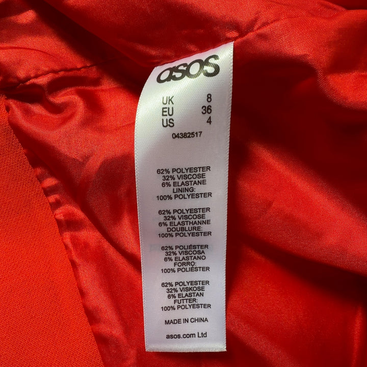 Red cropped utility jacket back view showing structured fit and cargo pocket details