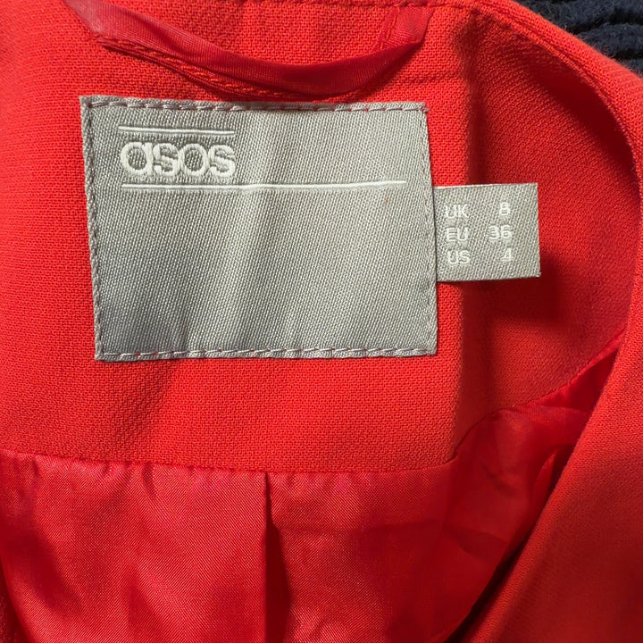 Red cropped utility jacket back view showing structured fit and cargo pocket details