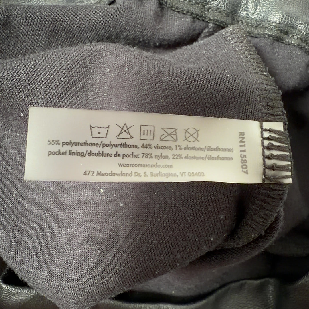 Black leather jogger pants with functional pockets, back view on model