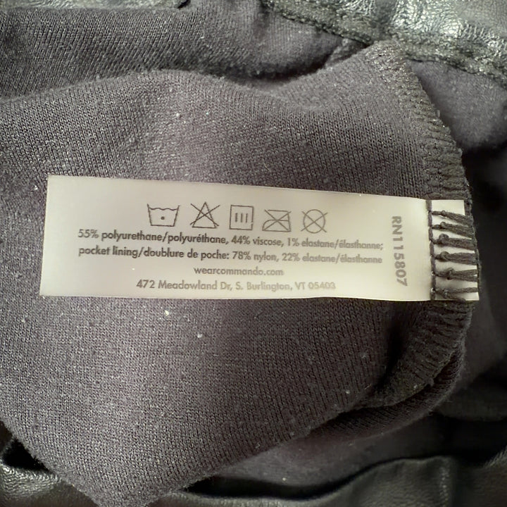 Black leather jogger pants with functional pockets, back view on model