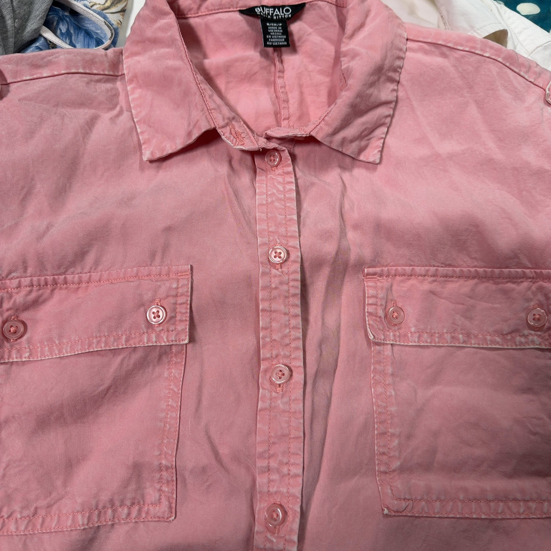 Tag view of pink short-sleeve button-up shirt showing relaxed fit and rolled sleeves