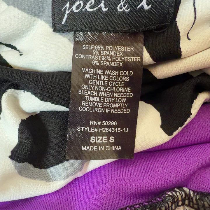 Black floral maxi dress with purple and white botanical print and purple waistband, back view