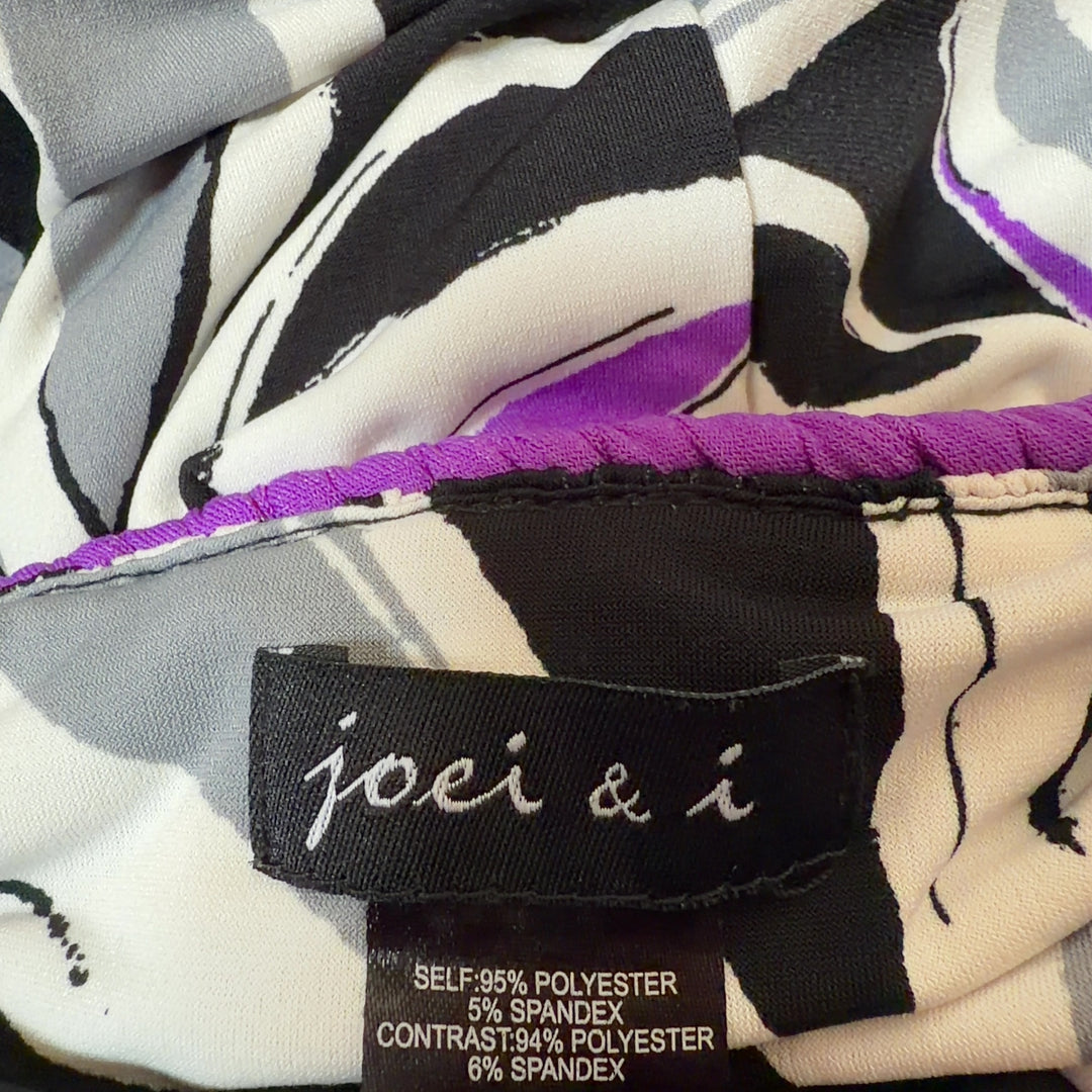 Black floral maxi dress with purple and white botanical print and purple waistband, back view