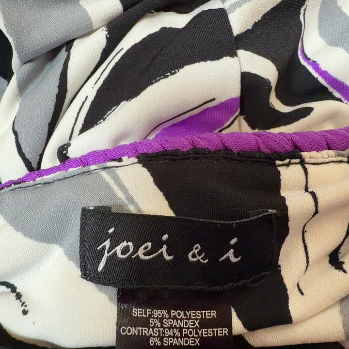 Black floral maxi dress with purple and white botanical print and purple waistband, back view