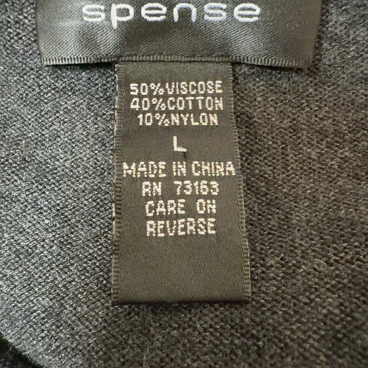 Tag view of charcoal striped pleated knit dress showing vertical stripe pattern and pleated skirt