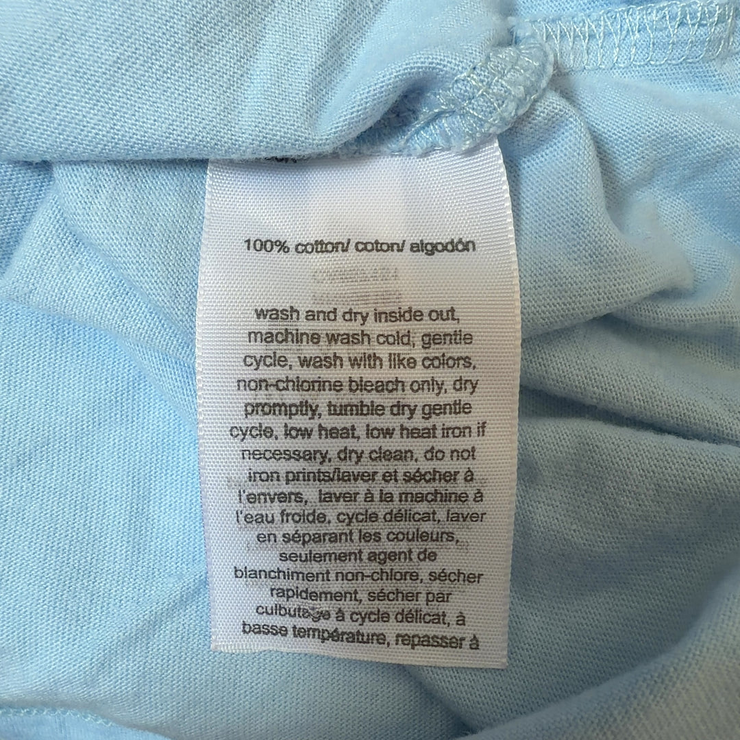Tag view of light blue Hilfiger Jeans tee showing colorblock logo print and relaxed fit silhouette