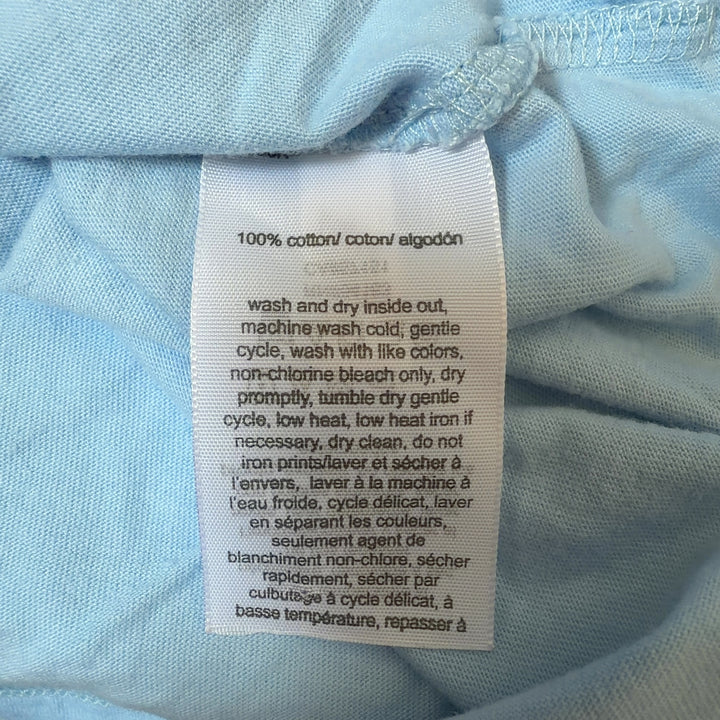 Tag view of light blue Hilfiger Jeans tee showing colorblock logo print and relaxed fit silhouette