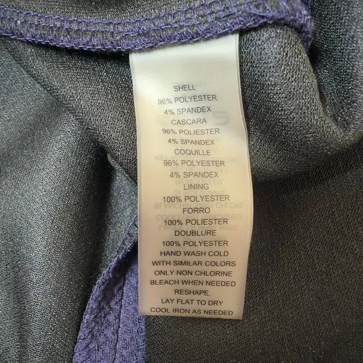 Tag view of navy shift dress displaying white lace trim detail running down the center back, showing relaxed fit and knee-length hem