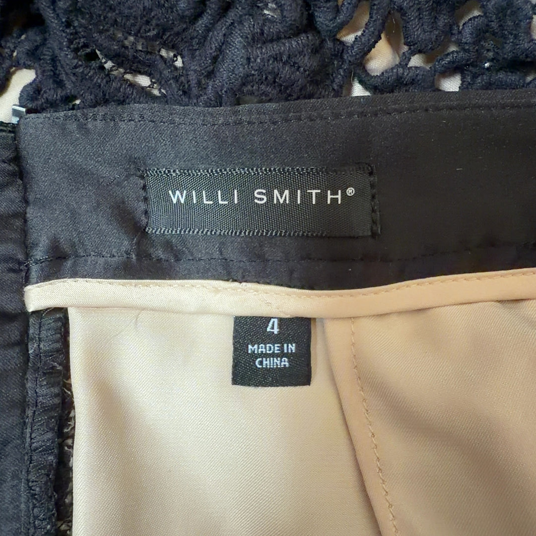 Black lace pencil skirt with scalloped hem by Willi Smith, back view showing elegant lace detailing