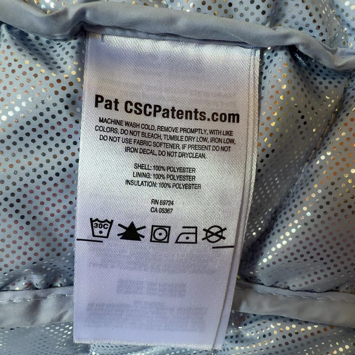 Tag view of navy Columbia puffer jacket showing quilted pattern and fitted waist design