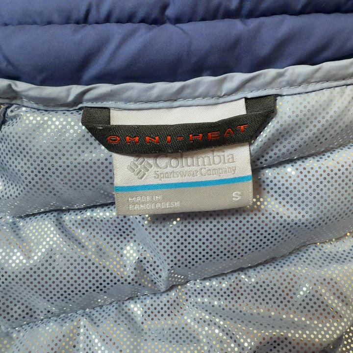 Tag view of navy Columbia puffer jacket showing quilted pattern and fitted waist design