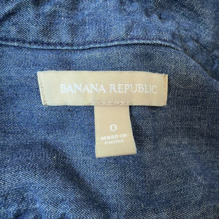 Blue denim button-up shirt dress with long sleeves and relaxed fit, back view