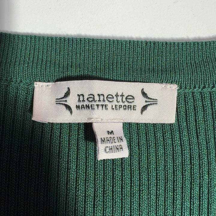 Tag view of green ribbed knit top with three-quarter sleeves and chain neckline by Nanette Lepore