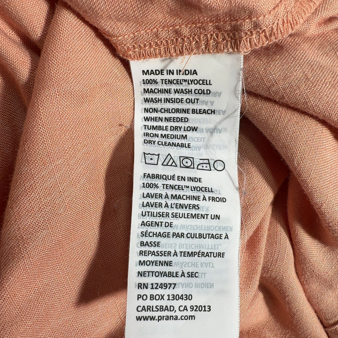 Tag view of peach Tencel Lyocell midi dress showing relaxed A-line silhouette and sleeveless design