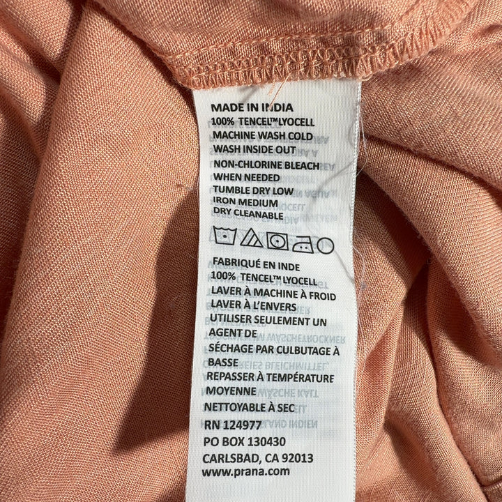 Tag view of peach Tencel Lyocell midi dress showing relaxed A-line silhouette and sleeveless design