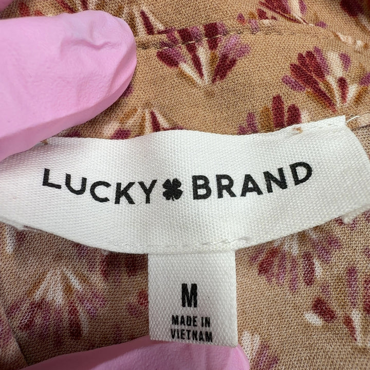 Beige floral button-down Lucky Brand midi dress with tie waist, back view on model