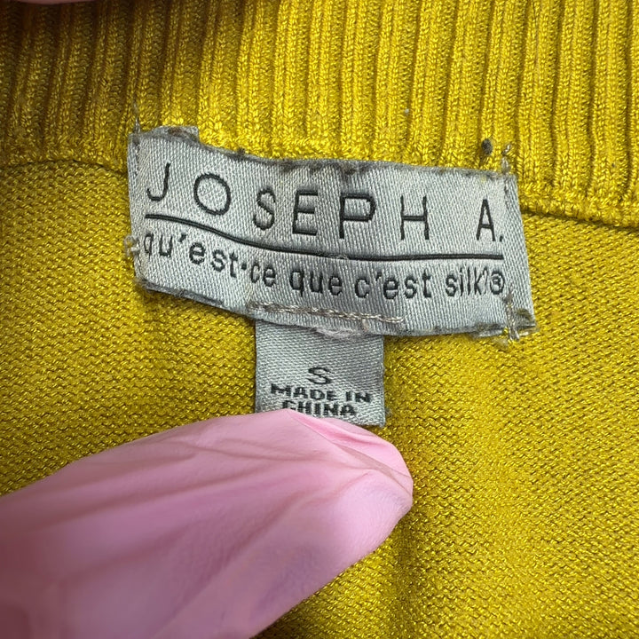 Black and yellow color-block knit sweater with white stripes and three-quarter sleeves, back view