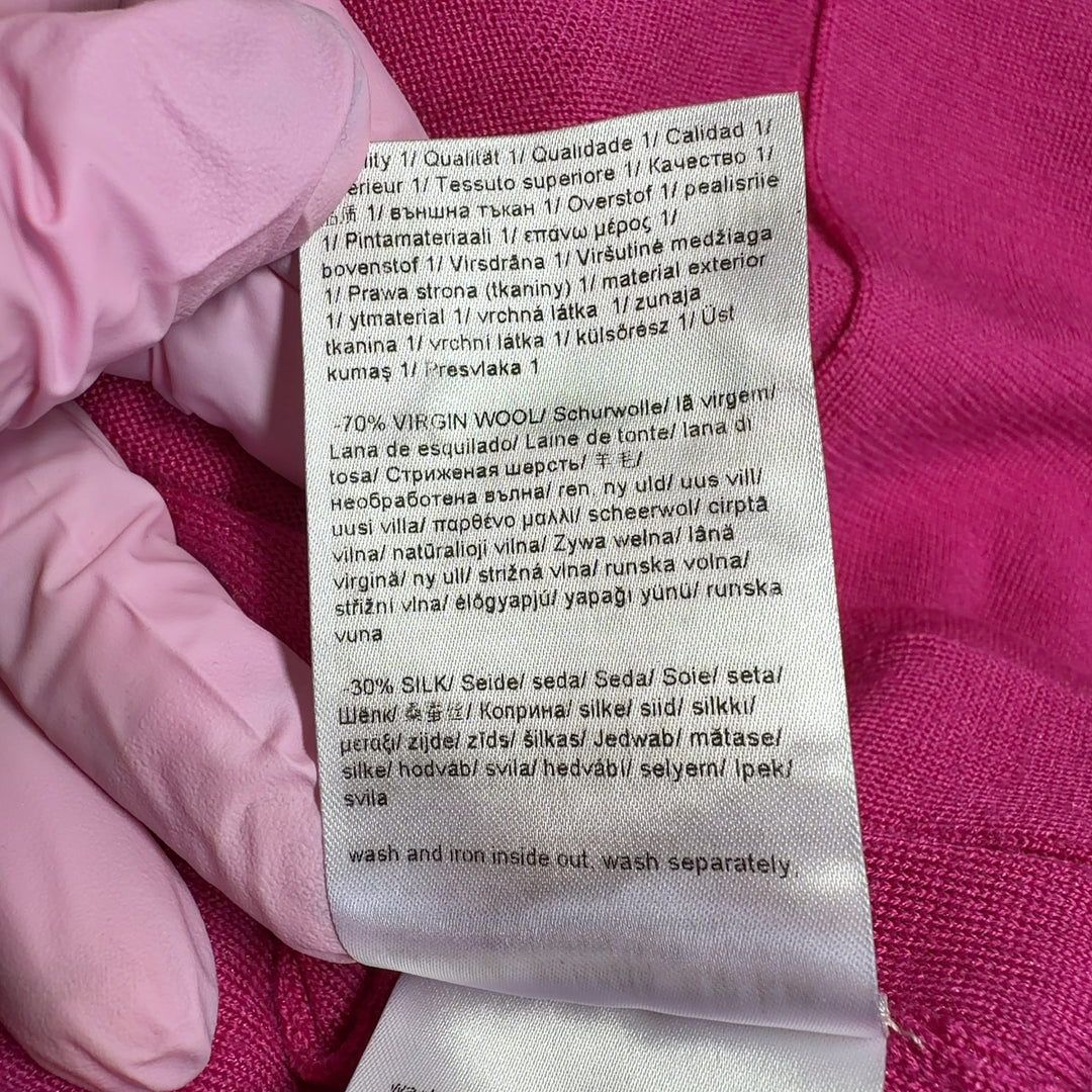 Tag view of pink ESCADA cardigan with long sleeves and flowing silhouette, styled with black pants