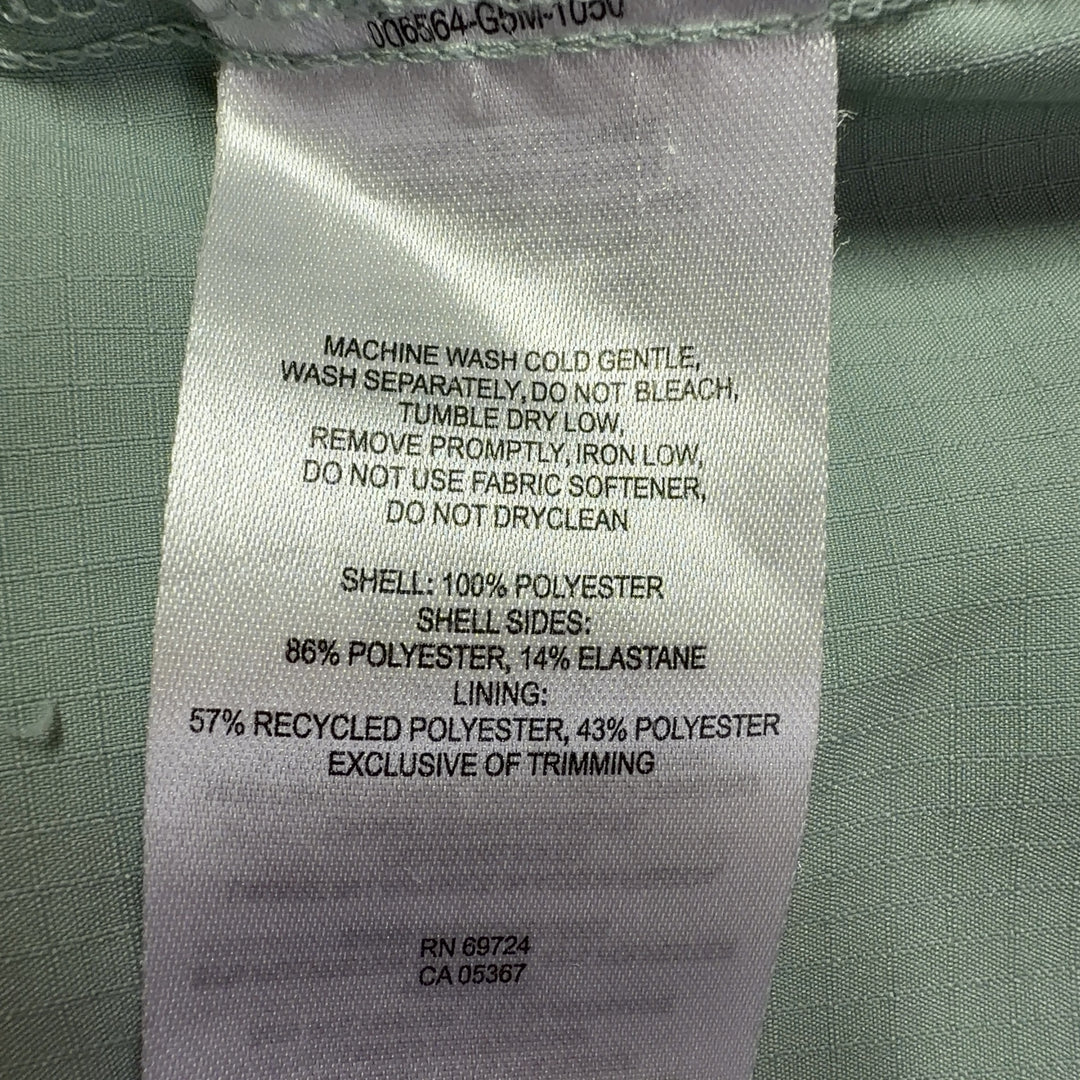 Sage green Columbia activewear shirt back view, showing button-up design and relaxed silhouette