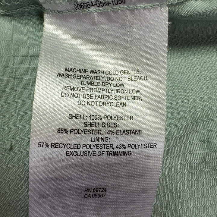 Sage green Columbia activewear shirt back view, showing button-up design and relaxed silhouette