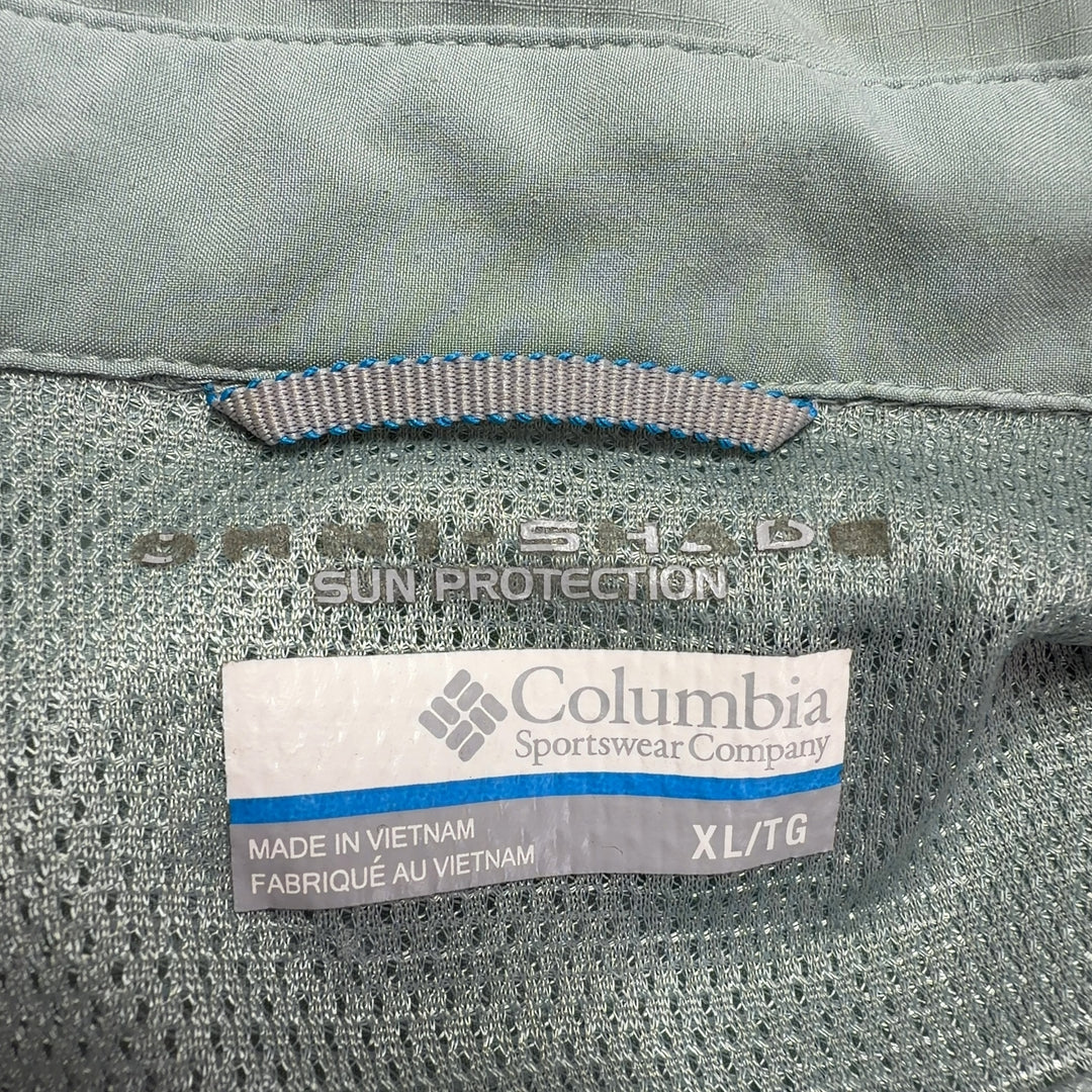 Sage green Columbia activewear shirt back view, showing button-up design and relaxed silhouette