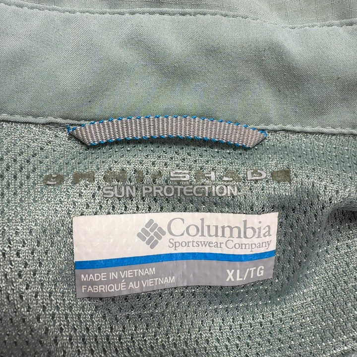 Sage green Columbia activewear shirt back view, showing button-up design and relaxed silhouette