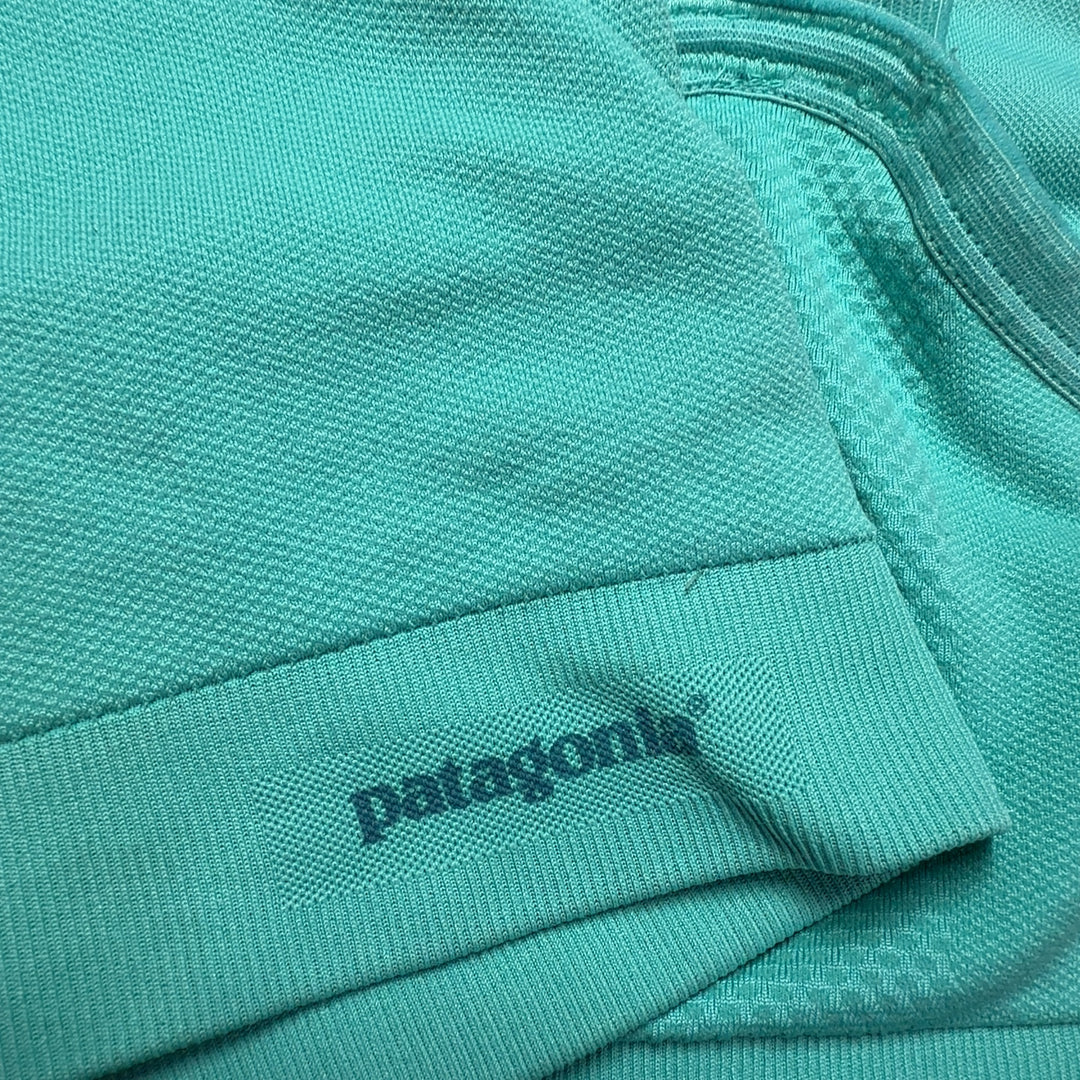 Turquoise sports bra back view showing supportive design and cropped silhouette