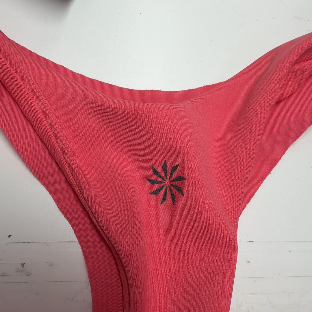 Tag view of pink Athleta tank top showing relaxed fit and draping design