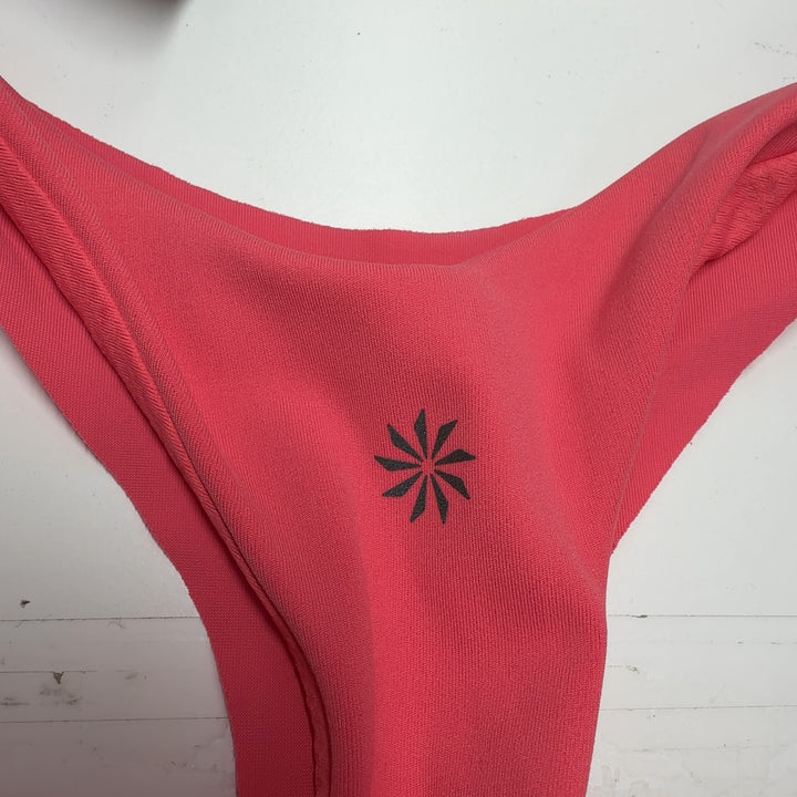 Tag view of pink Athleta tank top showing relaxed fit and draping design