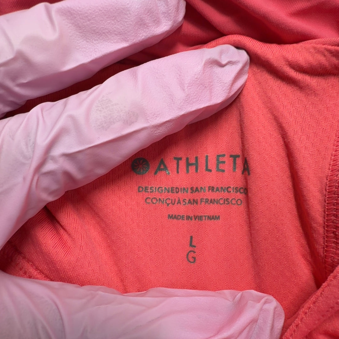 Tag view of pink Athleta tank top showing relaxed fit and draping design