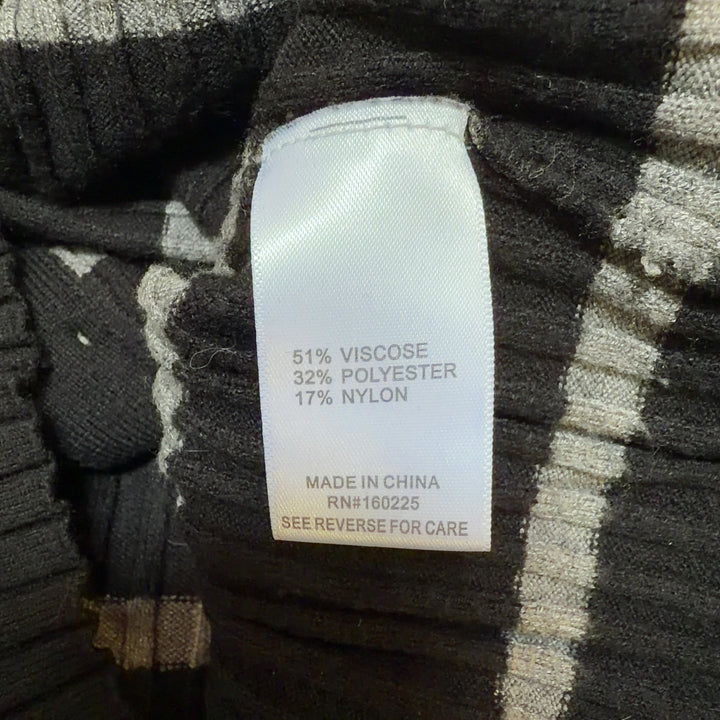 Tag view of black striped crop cardigan showing horizontal stripe pattern and fitted silhouette