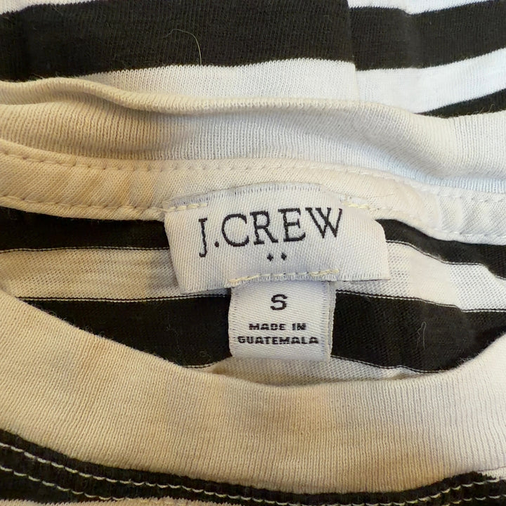 Tag view of black and white striped long sleeve cotton top showing relaxed fit and horizontal stripe pattern