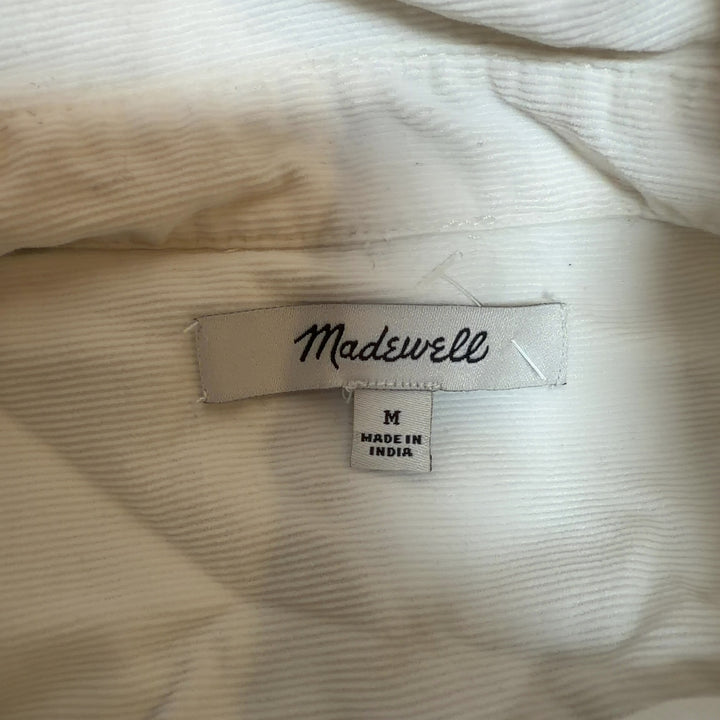 Cream cotton button-front shirt dress by Madewell, back view displaying oversized silhouette and midi length