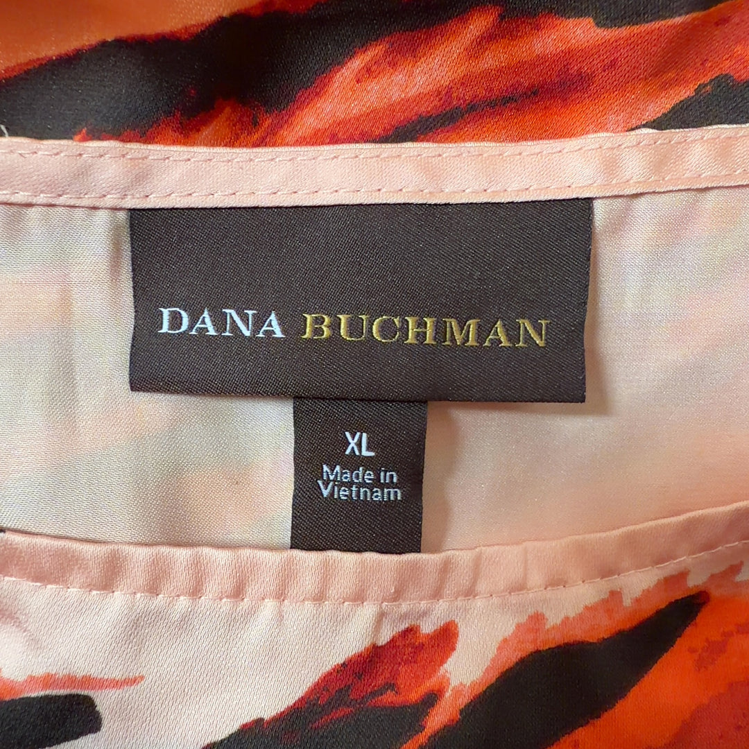 Orange and black striped Dana Buchman caftan top with asymmetrical flowing sleeves, back view on model