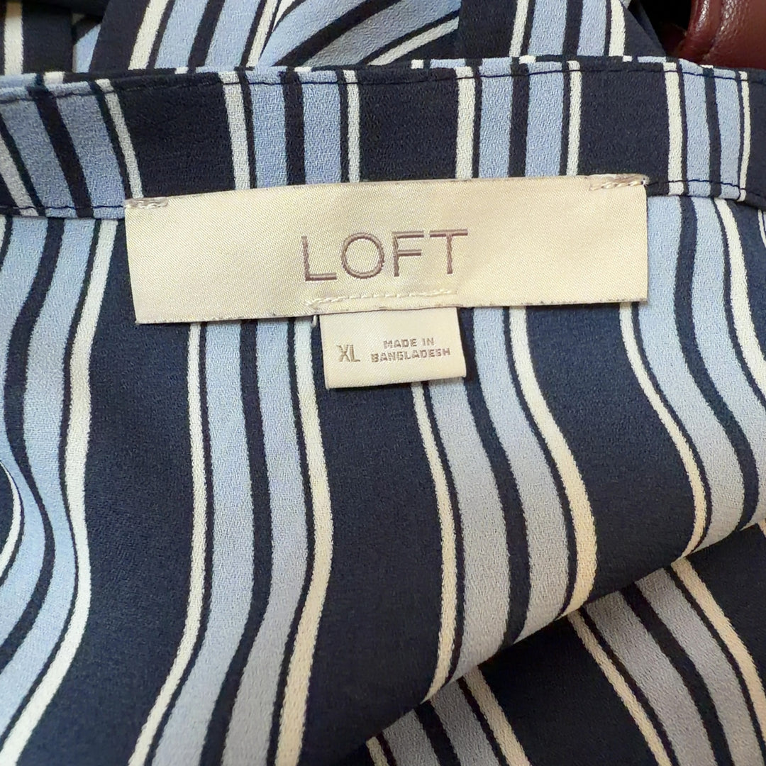Navy and white striped wrap blouse with side tie detail, back view on model