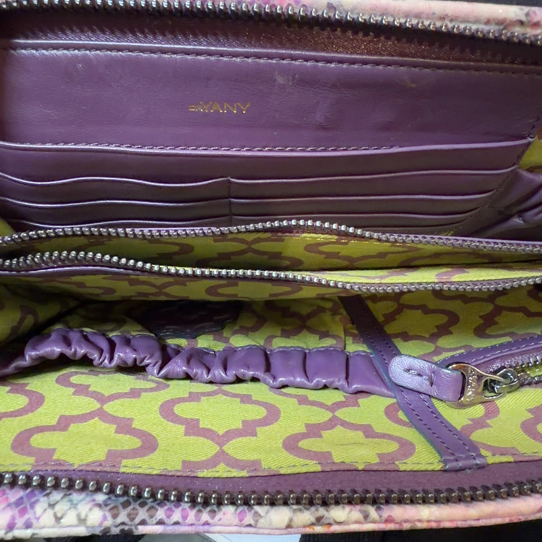 Pink python print orYANY clutch with chain strap styled with black outfit