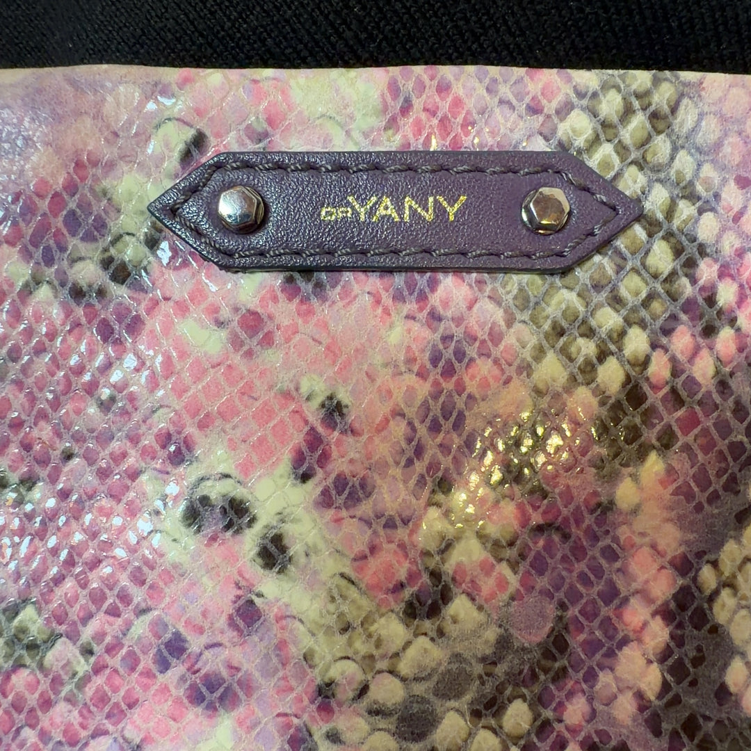 Pink python print orYANY clutch with chain strap styled with black outfit