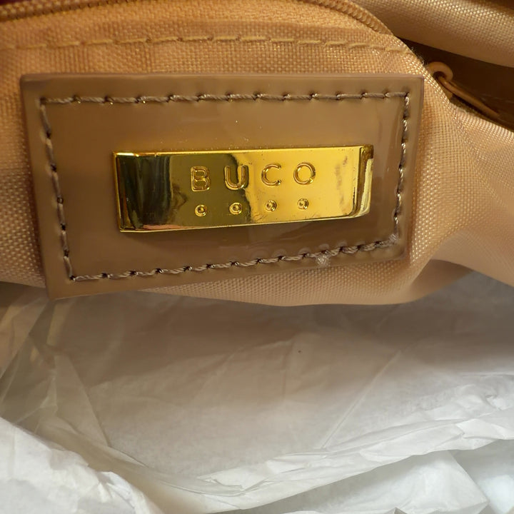 Tag view of gold lace cutout shoulder bag worn on model's shoulder