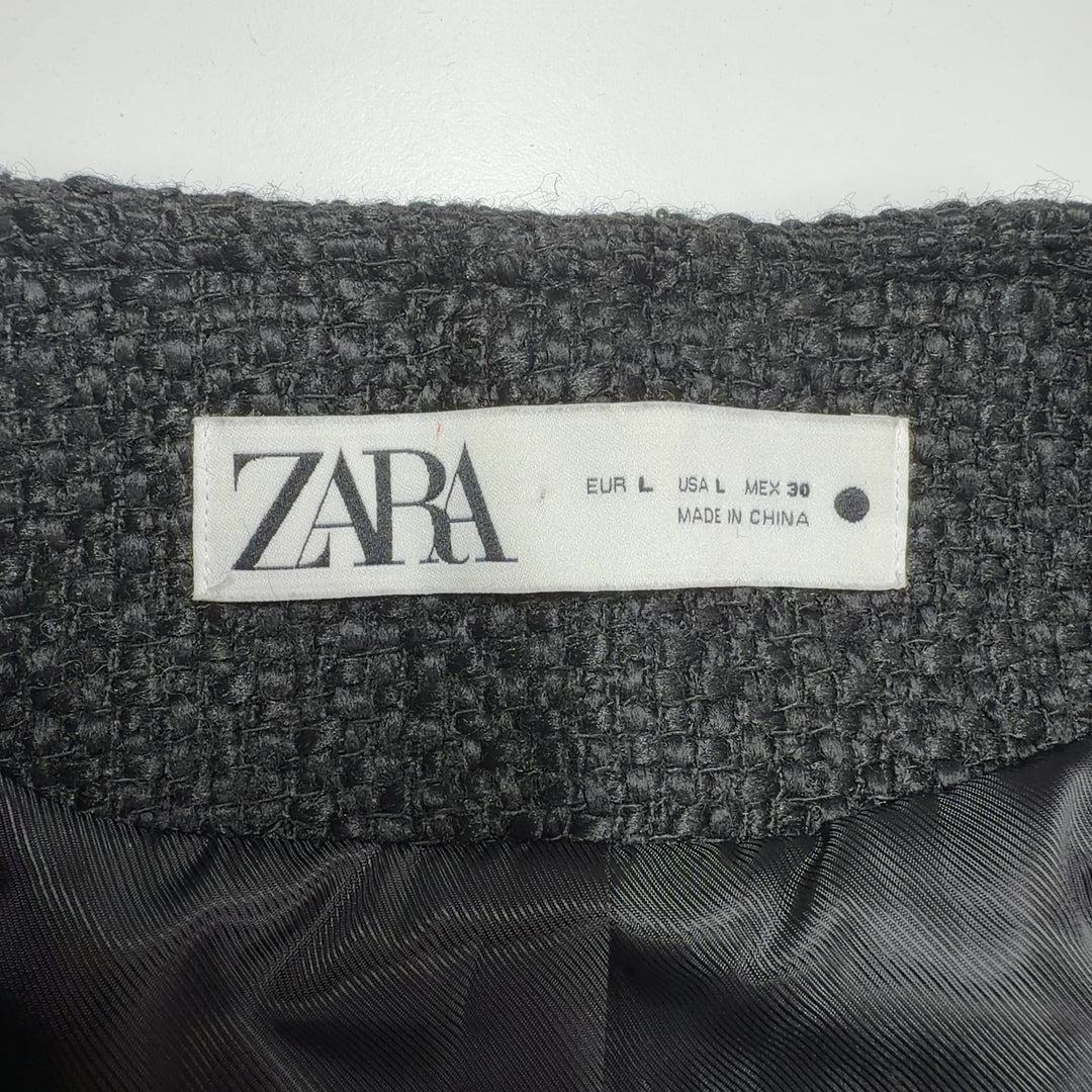 Tag view of charcoal wool blazer showing tailored fit and gold button detailing