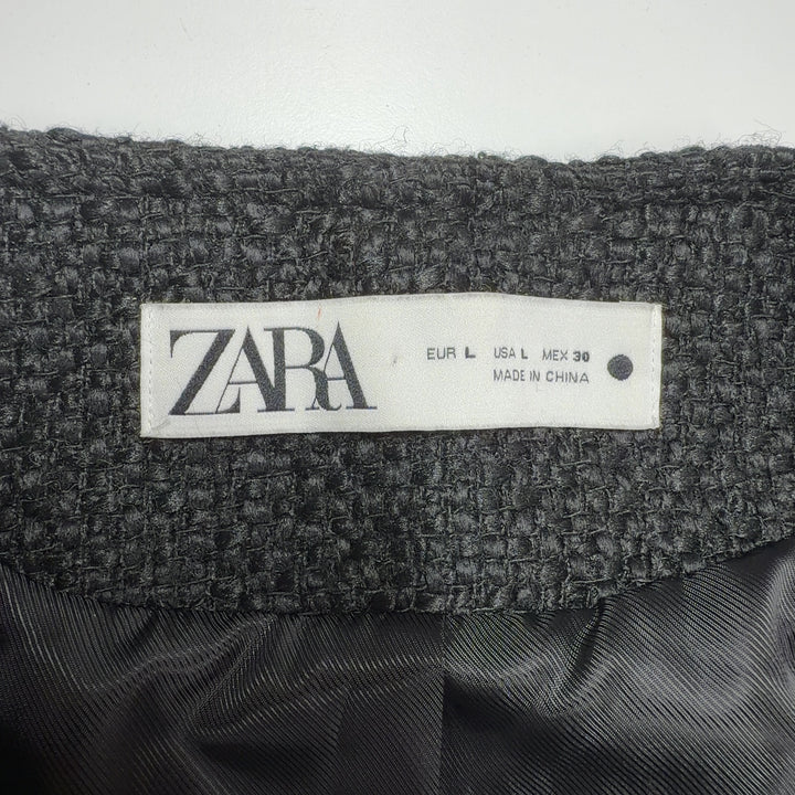 Tag view of charcoal wool blazer showing tailored fit and gold button detailing