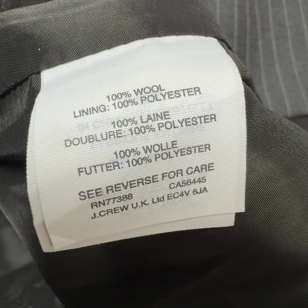 Black pinstriped wool midi dress with belted waist, back view