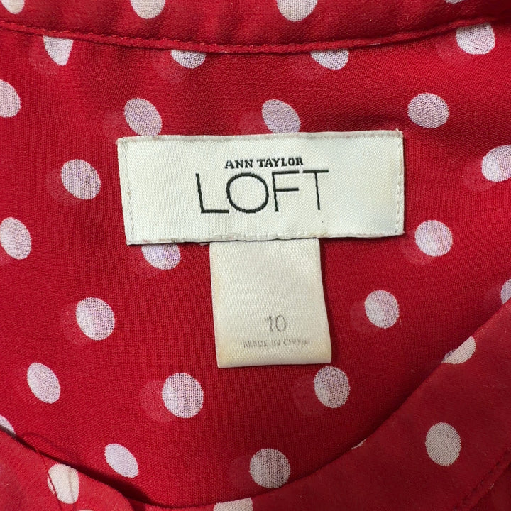 Tag view of red polka dot blouse showing relaxed fit and short sleeve design