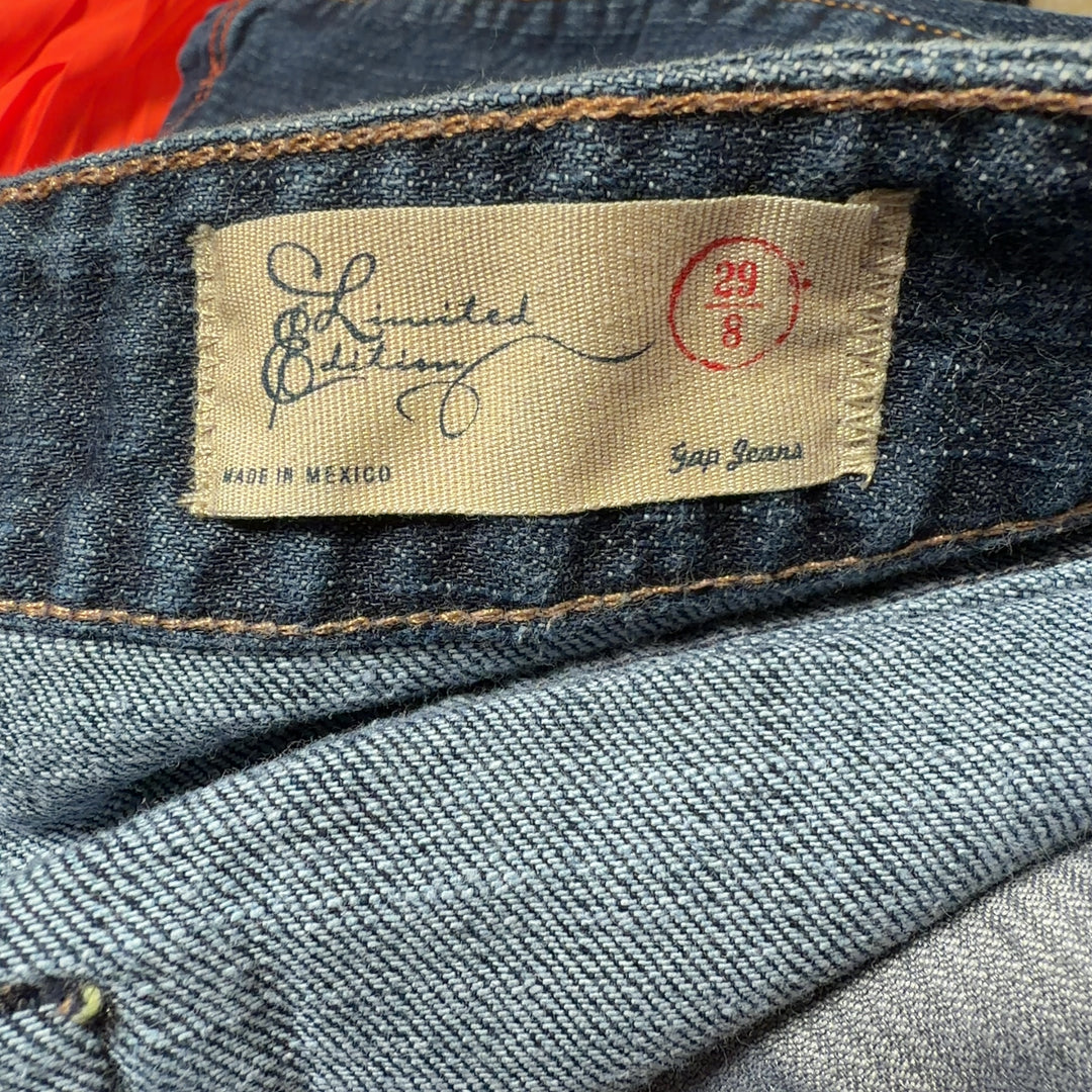 Dark blue denim knee-length skirt back view, showing classic denim construction and fit