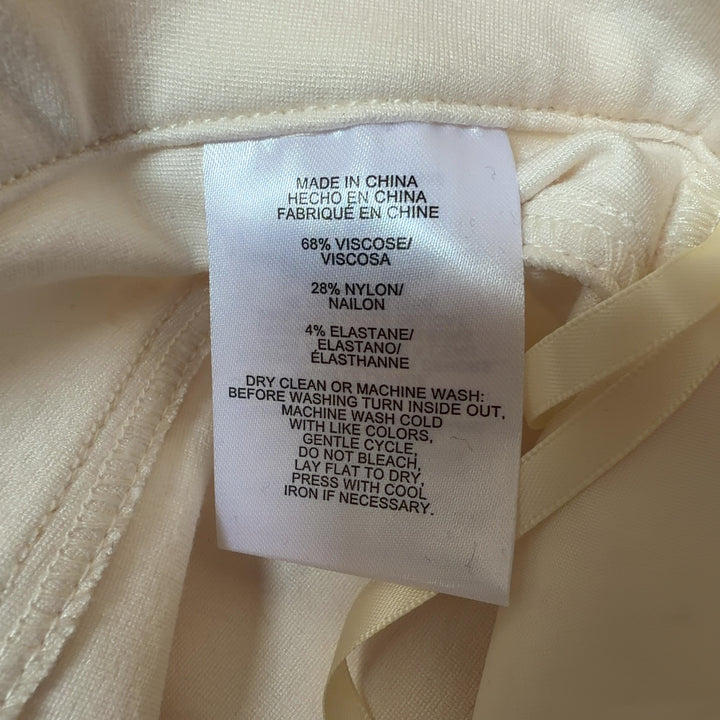 Tag view of cream dress pants showing classic tailoring and comfortable stretch fit