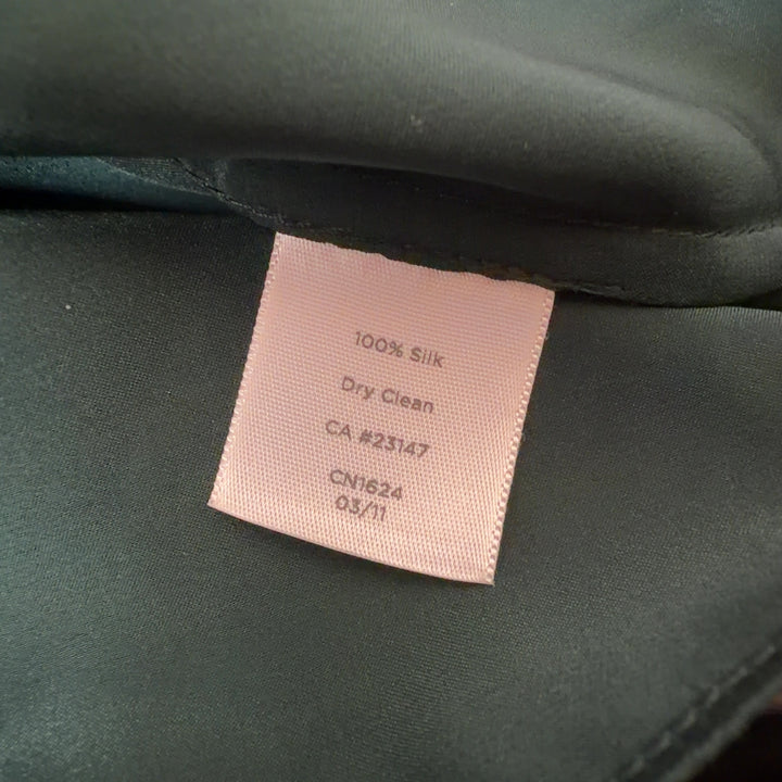 Tag view of green silk ruffle tank top by Talbots showing ruffle detailing and sleeveless cut